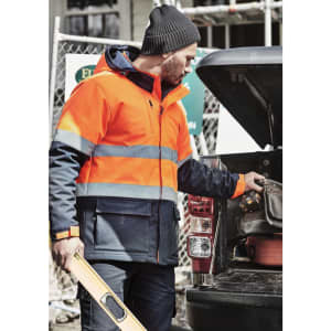 A unisex softshell jacket featuring high visibility orange and navy, with reflective stripes and a logo.