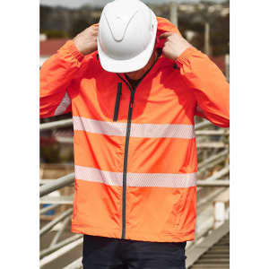 A vibrant orange packable rain jacket with reflective stripes, worn by a person in a hard hat.