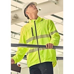 A bright yellow rain jacket with reflective stripes, worn by a person in a safety helmet, standing indoors.