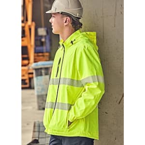 A bright yellow packable rain jacket with reflective stripes, worn by a person standing against a wall.