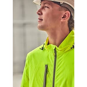 A vibrant yellow packable rain jacket is worn by a person looking upwards, complemented by a hard hat.