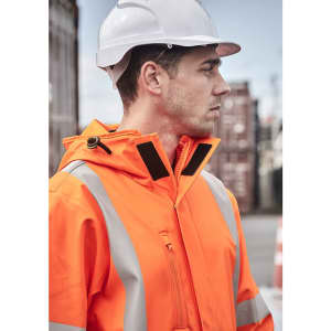 An orange heavy-duty waterproof jacket with reflective strips, worn by a person in a hard hat.