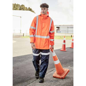 A heavy-duty waterproof jacket in fluorescent orange with reflective strips, worn by a model in blue work pants.