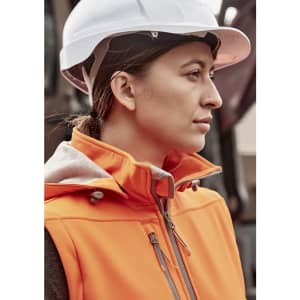 An orange women's softshell jacket with a zipper, worn by a woman in a white hard hat.