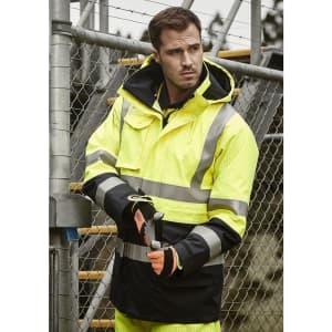 A men's waterproof jacket in bright yellow and black, featuring reflective stripes and a logo, worn by a man.