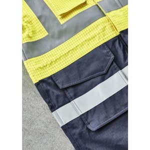 A bright yellow and dark navy jacket featuring reflective strips and multiple pockets, with a logo present.