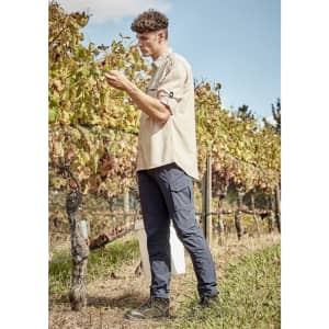 Men's lightweight outdoor pants in navy, featuring cargo pockets, worn by a person in a vineyard setting.
