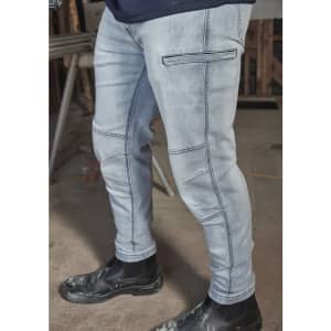 A pair of light blue stretch jeans with cargo-style pockets, worn with black work boots.
