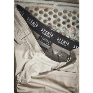 A pair of beige cargo shorts with a branded waistband, featuring multiple pockets and a casual design.