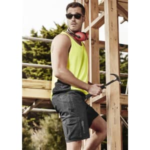 A man wearing a vibrant yellow athletic tank top and dark grey board shorts, with sunglasses and headphones, poses with a hammer.