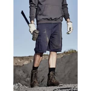 A pair of navy blue men's cargo shorts with multiple pockets, being worn by a person holding a tool.