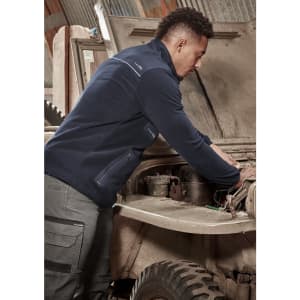 A person wearing a navy lightweight 1/4 zip polar fleece working on a vehicle under the hood, featuring a logo.