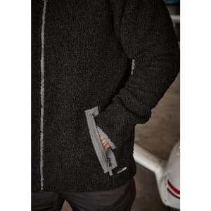 A black unisex full zip sherpa fleece jumper with side pockets and a logo.