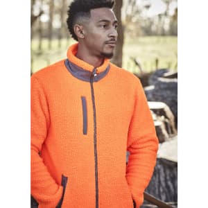 A man wearing an orange unisex full zip sherpa fleece, featuring a high collar and zippered front pockets.