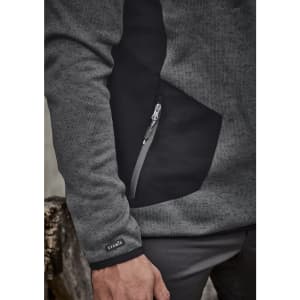 A grey and black unisex pullover featuring a zippered pocket and a logo on the sleeve.