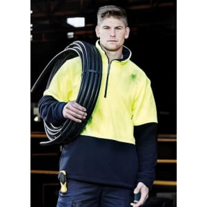 A unisex hi-vis yellow and navy polar fleece pullover with a half zip and a logo, held by a person with a cable.