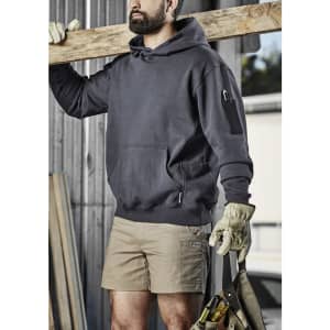 A dark grey unisex multi-pocket hoodie, worn by a person holding a wooden beam, featuring an attached logo.