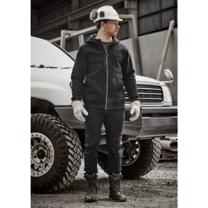 A man wearing a black unisex zip front multi-pocket hoodie, gloves, and work boots, standing next to a white vehicle.