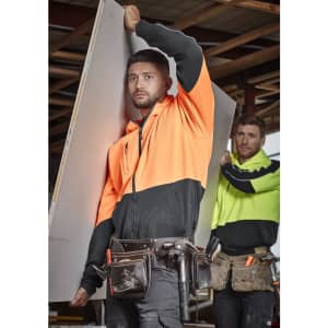 Unisex hi-vis full zip hoodie in orange and black, featuring a logo, worn by a model on a construction site.