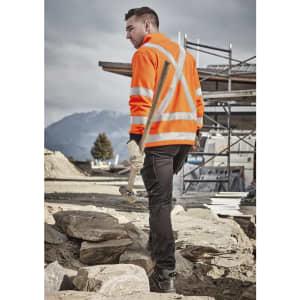 A unisex hi vis orange jumper with reflective X-back stripes, set against a construction site backdrop.