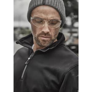 A black water-resistant pullover featuring a 1/4 zip and a collar, worn by a man with glasses and a grey beanie.
