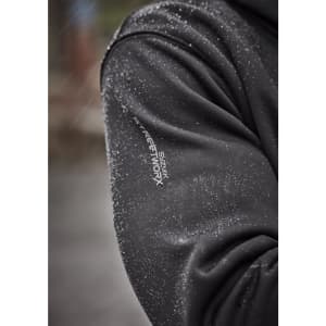 A close-up of a black water-resistant hoodie with a logo on the sleeve, featuring droplets of water on the fabric.