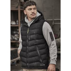A black unisex hooded puffer vest worn over a grey sweatshirt, featuring a small logo and zip pockets.