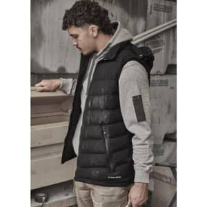 A black unisex hooded puffer vest worn over a grey sweatshirt, featuring a small logo on the vest.