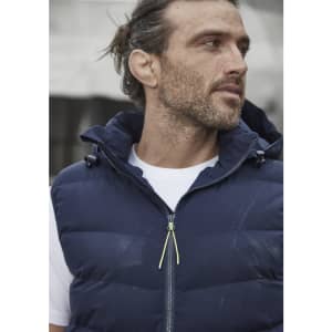 A unisex hooded puffer vest in navy blue, featuring a zip front and a hood, displayed on a model.