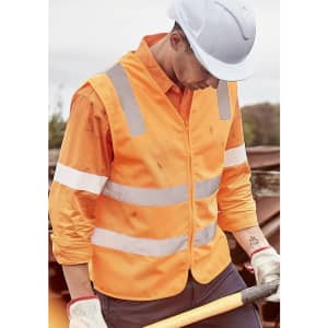 A high visibility orange zip vest with reflective stripes worn by a person in work attire.