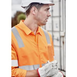 A man wearing an orange hi-vis zip vest with reflective strips and a white hard hat, holding a sausage.