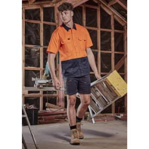 A short sleeve work shirt in hi-vis orange and navy blue, designed for safety and visibility in construction settings.