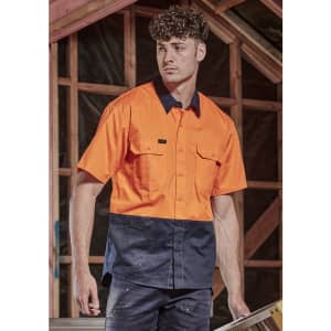 A short sleeve work shirt in bright orange and navy blue, featuring two chest pockets and a logo.