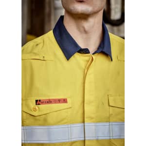A yellow and navy work shirt with reflective hoop tape and a logo on the chest.