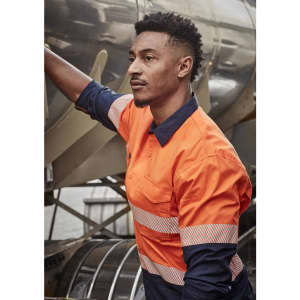 A long sleeve work shirt in orange and navy with segmented reflective tape, featuring a logo on the chest.