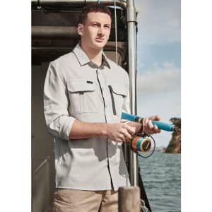 A light grey long sleeve button-up shirt with two chest pockets, worn by a man holding a fishing rod by the water.