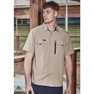 A light beige men's short sleeve button-up shirt with two chest pockets and a zipper pocket, featuring a logo.