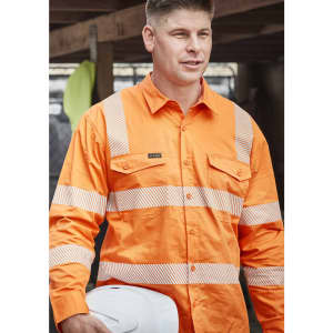 An orange long-sleeve work shirt with segmented reflective tape and a logo, worn by a man holding a white hard hat.