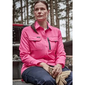 A long sleeve women's button-up shirt in bright pink with two front pockets and a zippered chest pocket.