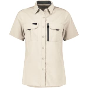 A short sleeve women's outdoor shirt in light beige, featuring two front pockets and a zip pocket, with a logo.