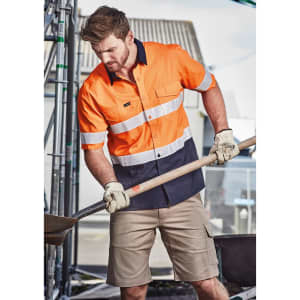 A short sleeve shirt in orange and navy with reflective tape, designed for workwear purposes. It features a branded logo.
