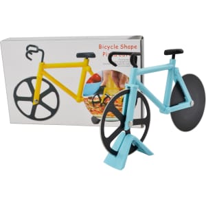 A bicycle-shaped pizza cutter in blue and yellow, displayed with its packaging in the background.