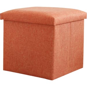 An orange foldable storage ottoman with a padded top and textured fabric, designed for home organisation.