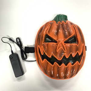 A pumpkin-shaped mask in orange with green stem, featuring a menacing face, and attached to a black battery pack.