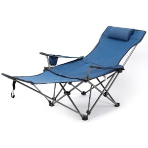A blue camping lounge chair with a reclining design, armrest, and a small headrest pillow. It has a logo on the frame.