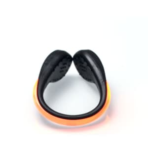 An LED clip-on shoe light in black with an orange light strip, featuring a curved design.