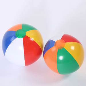 Two vibrant beach balls featuring a mix of red, blue, green, yellow, and white panels, each with a logo.