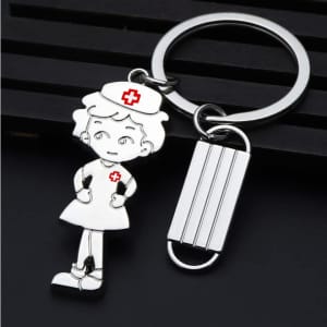 A silver keychain featuring a nurse character and a hospital mask design, accented with red details.