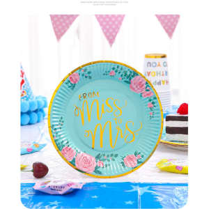 A round paper plate in teal with pink roses, featuring the text "From Miss to Mrs" in yellow. It has a decorative edge.
