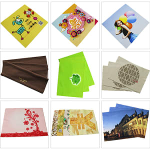 A collection of colourful microfiber cleaning cloths featuring various designs, including floral patterns and playful graphics.